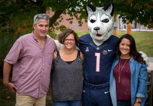 family with parents, student and uconn husky mascot